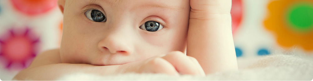 A baby lying on a blanket.